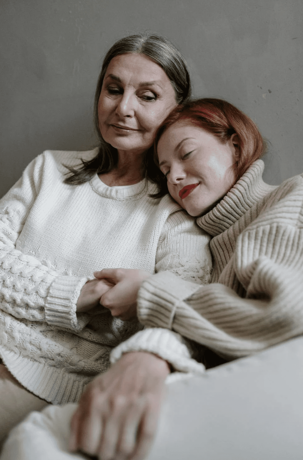 Daughter leaning on her mother for emotional support. 